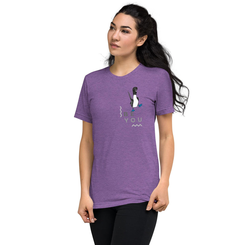 Purple triblend t-shirt featuring Be You in bold text with a detailed illustration of a blue-footed booby. Soft, lightweight fabric with a comfortable fit, showcasing lifelike textures in the artwork.