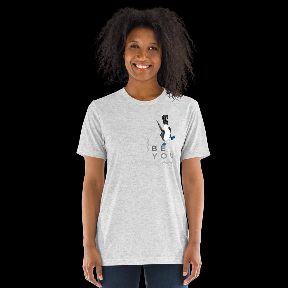 White fleck triblend t-shirt featuring Be You in bold text with a detailed illustration of a blue-footed booby. Soft, lightweight fabric with a comfortable fit, showcasing lifelike textures in the artwork.