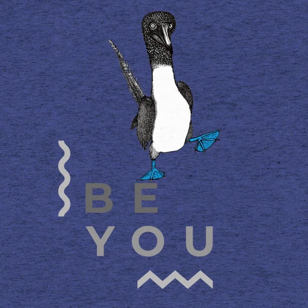 Navy triblend t-shirt featuring Be You in bold text with a detailed illustration of a blue-footed booby. Soft, lightweight fabric with a comfortable fit, showcasing lifelike textures in the artwork.